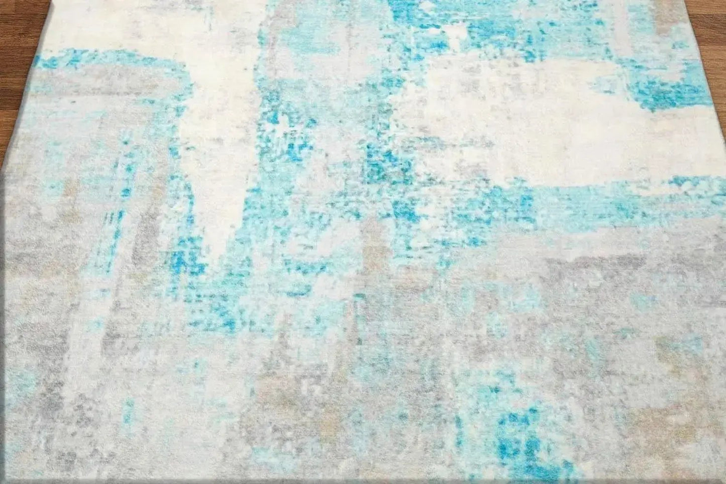 Abstract patterned rug with blue and gray colors on a wooden floor.