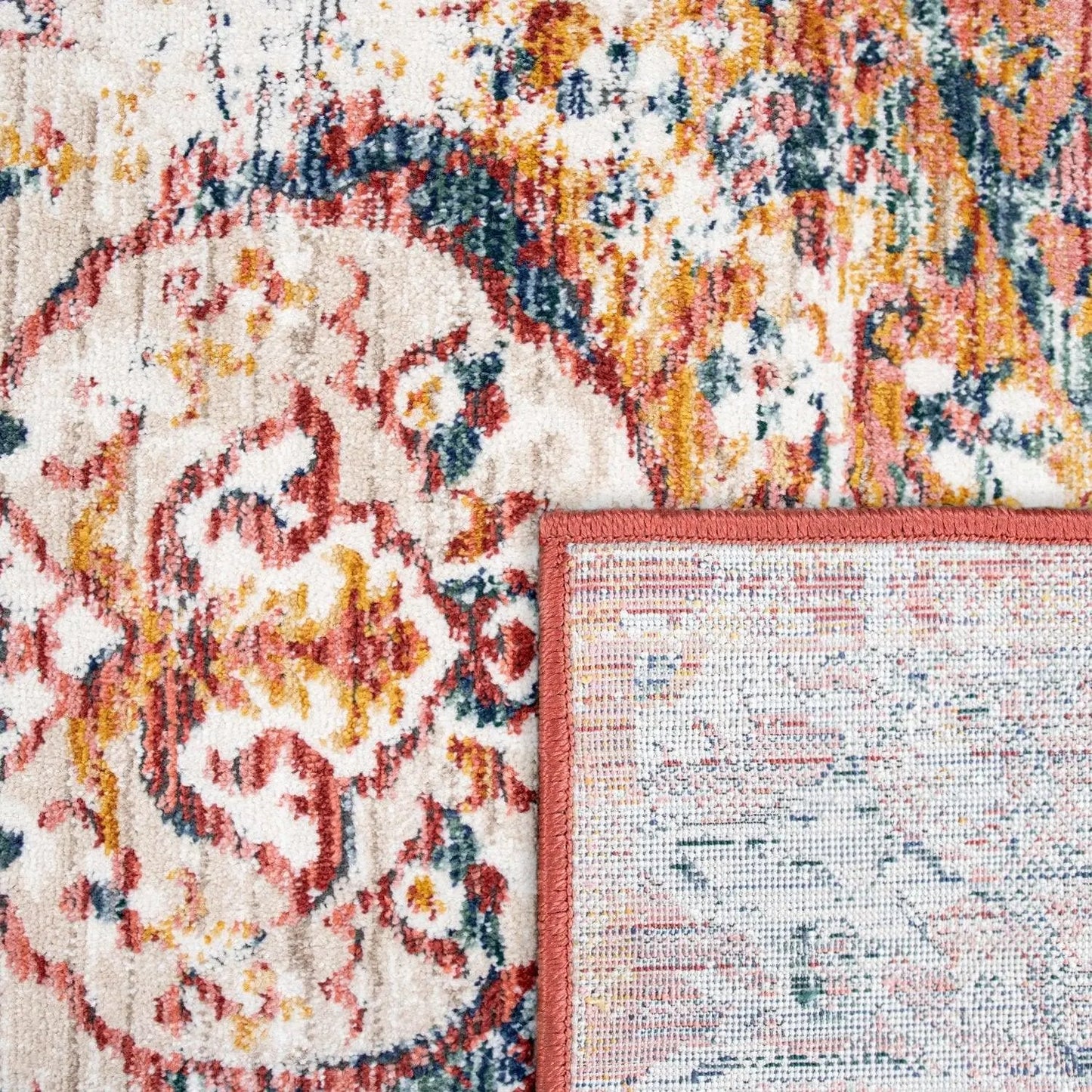 Close-up of a patterned rug with a multicolor design and a contrasting border.