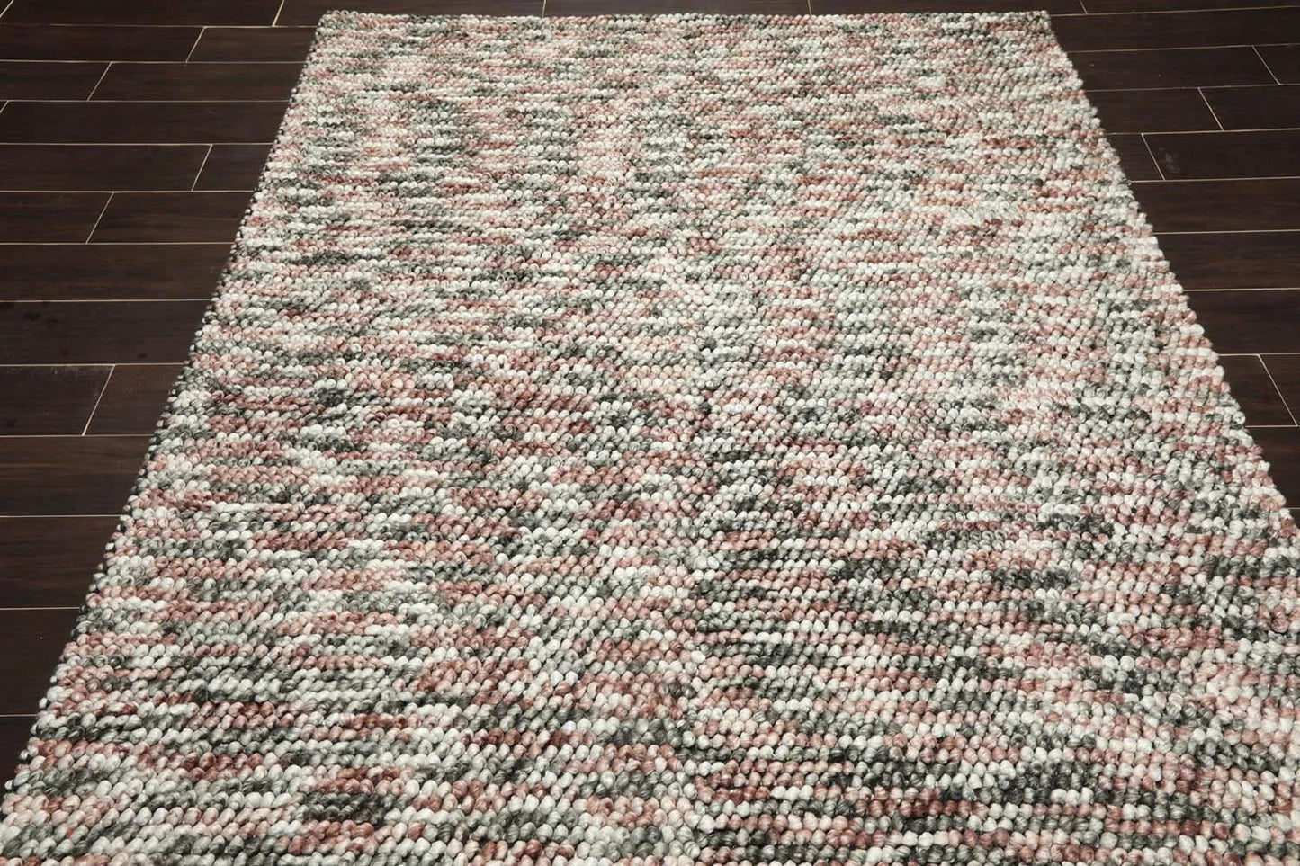 Multicolored textured rug on a wooden floor