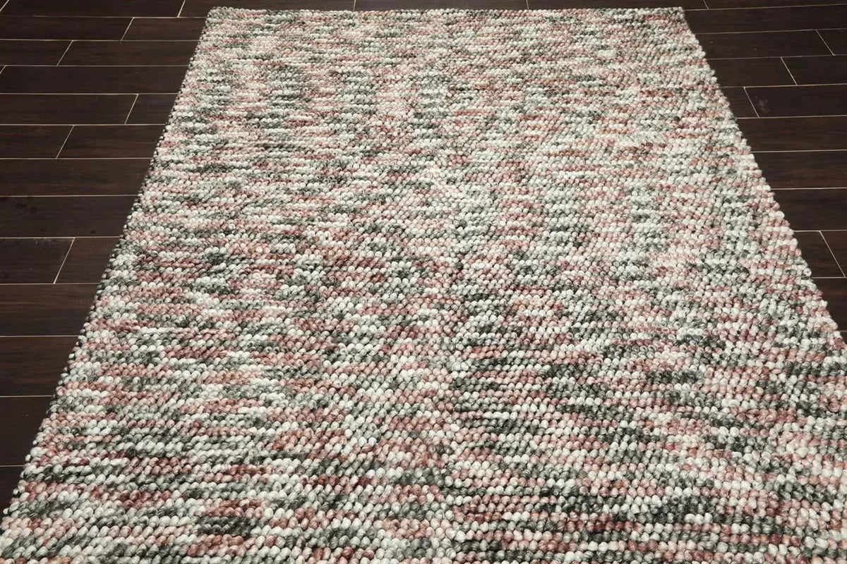 Multicolored textured rug on a wooden floor
