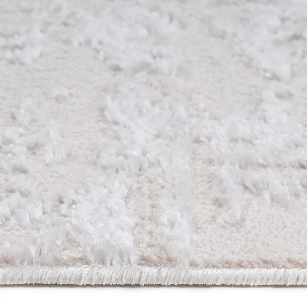 Close-up of a textured white rug with a subtle pattern