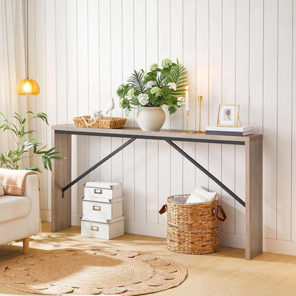 Modern interior with a console table, plants, and decorative items against a white paneled wall.
