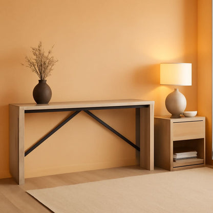 Modern console table with decorative items against a warm orange wall.