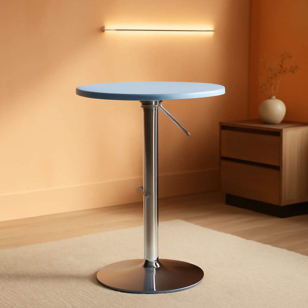 Modern round table with a blue top and metal base in a room with warm lighting.