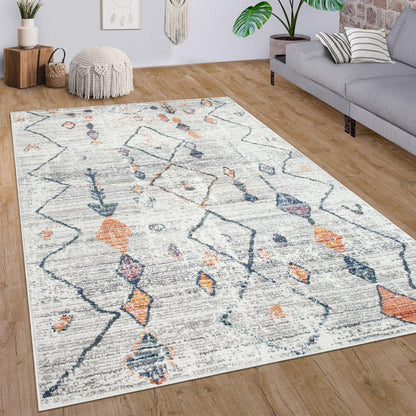Decorative area rug with geometric pattern on wooden floor