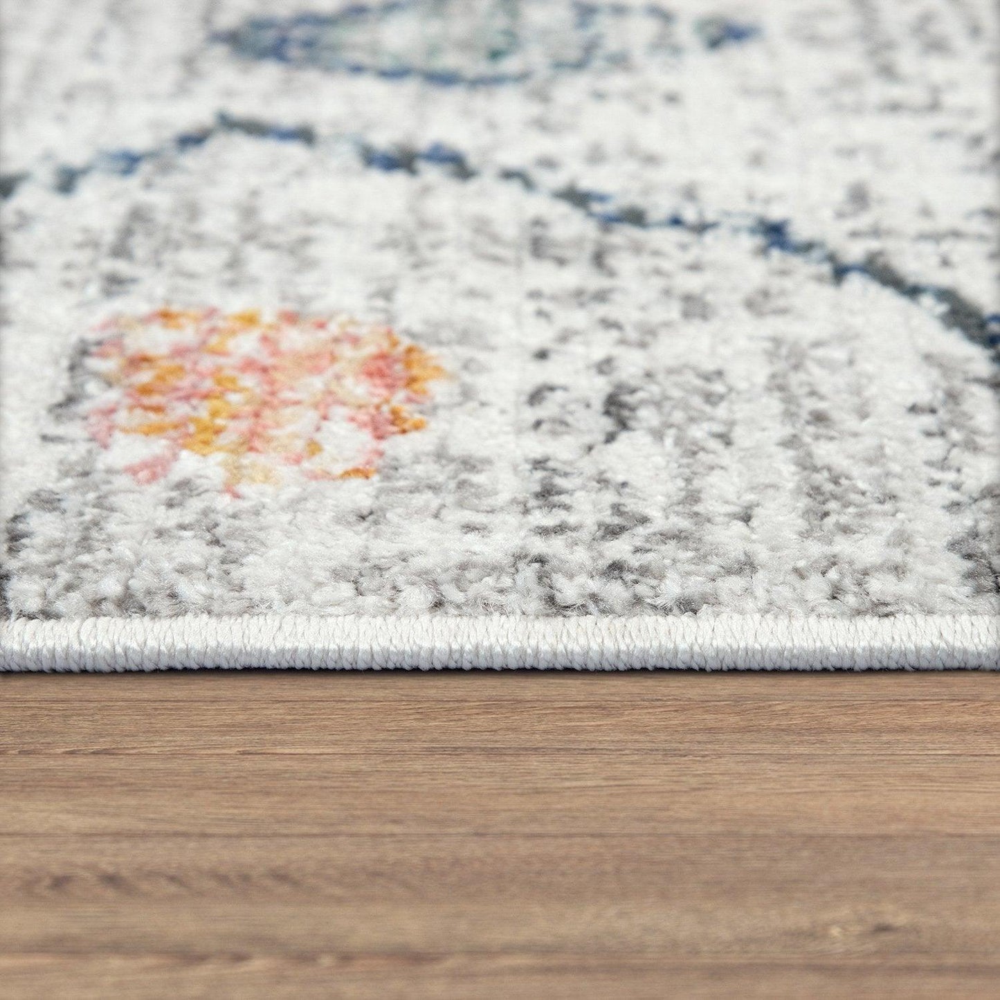 Close-up of a patterned rug on a wooden floor