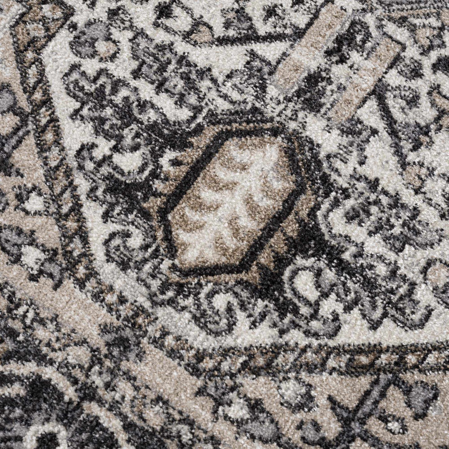 Close-up of a patterned rug with intricate designs.