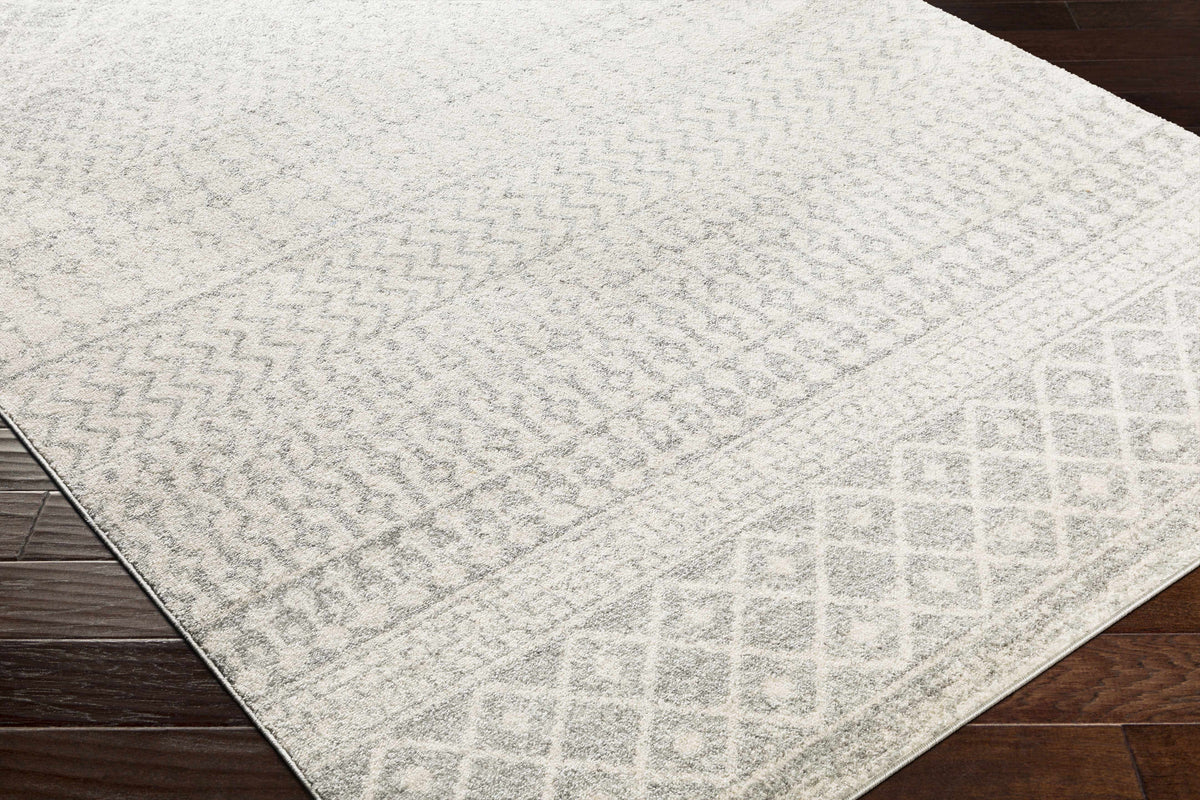 White textured rug on a wooden floor