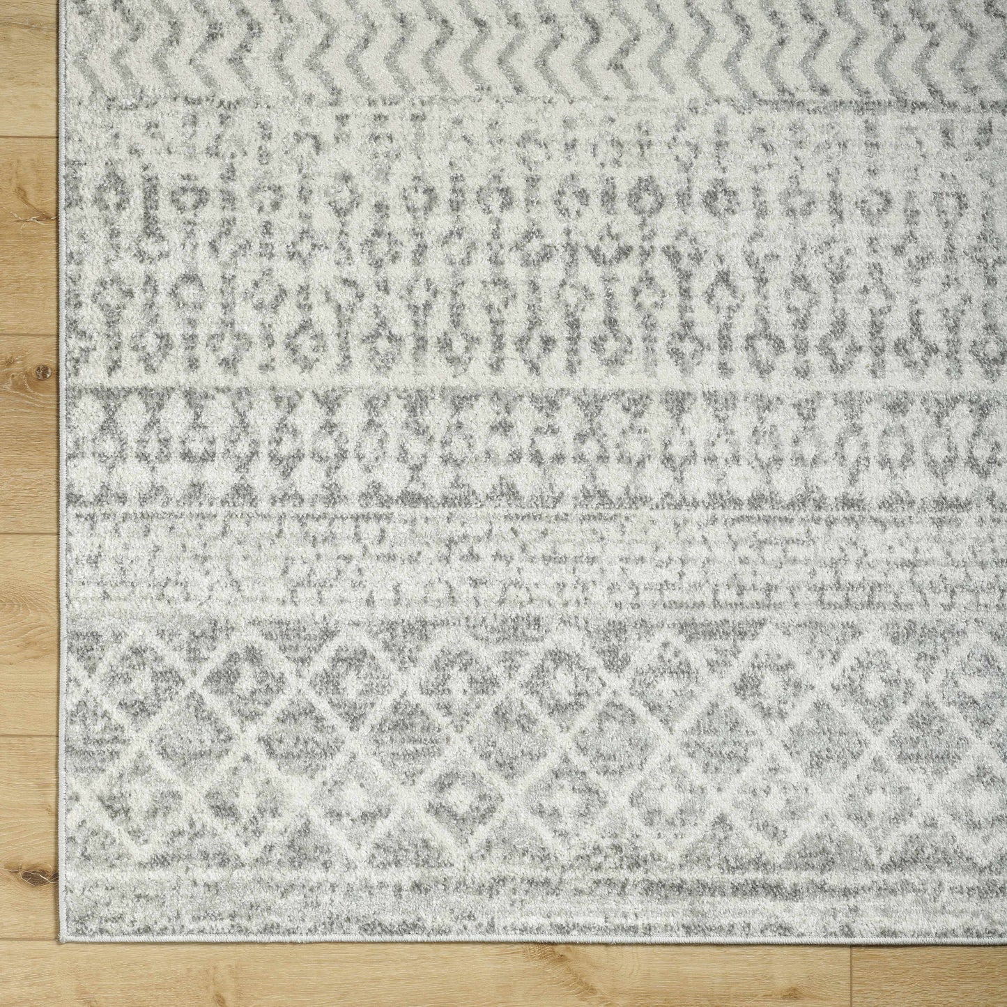 Patterned rug on a wooden floor