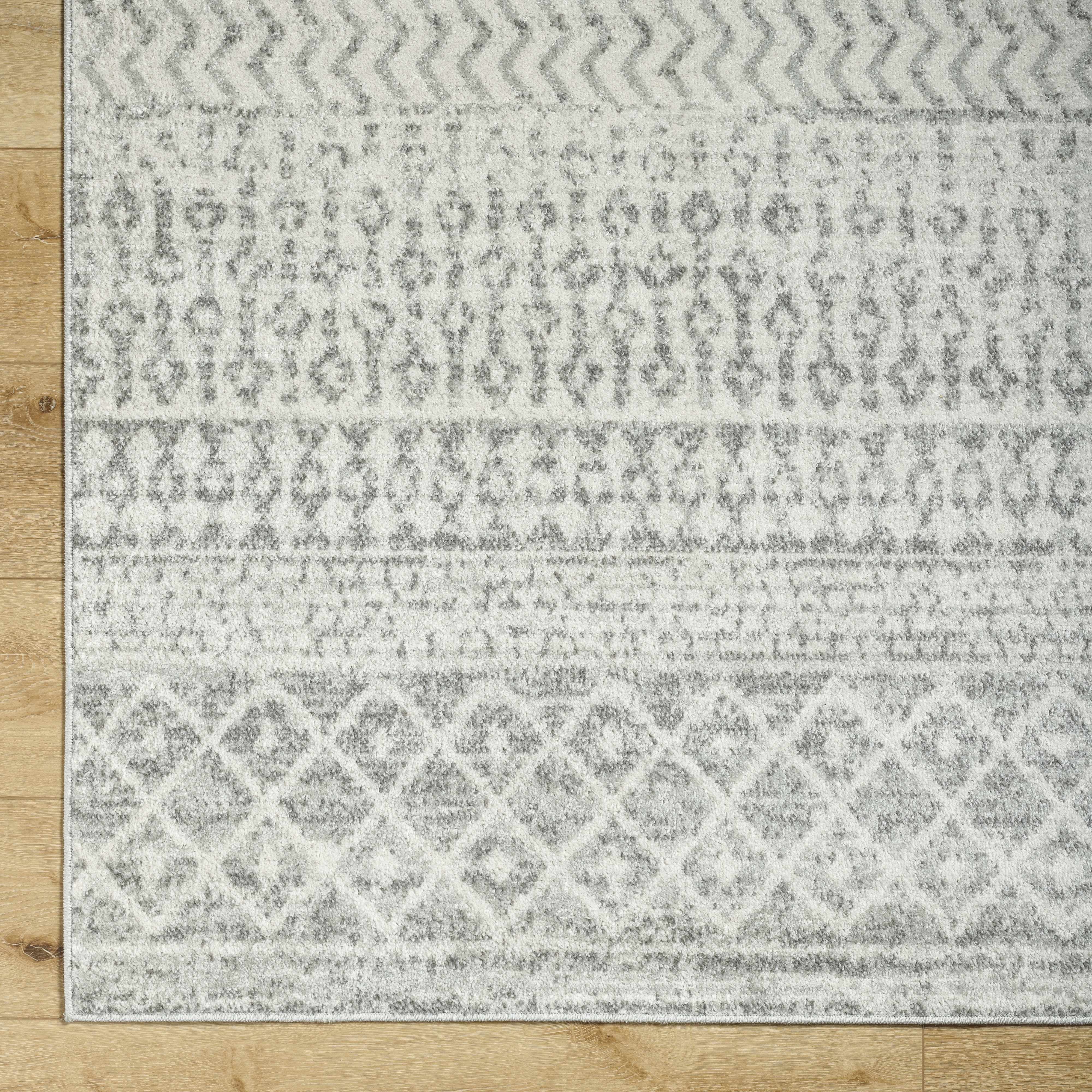 Patterned rug on a wooden floor