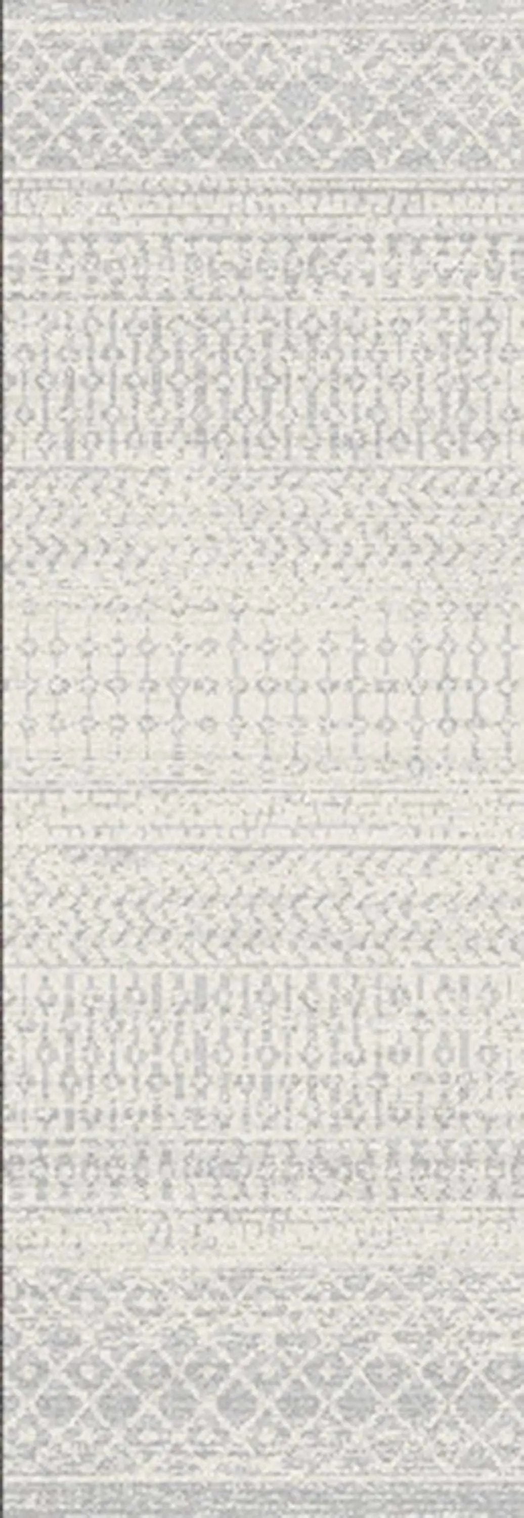 A close-up of a light gray and off-white patterned textile or rug with horizontal woven bands and geometric motifs.