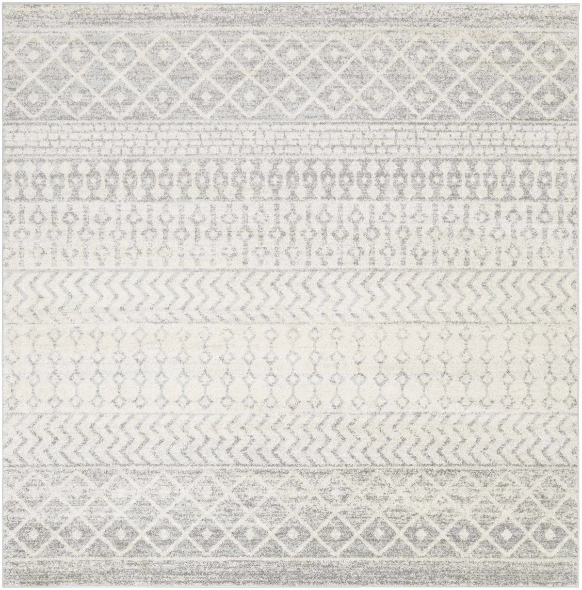 A square area rug with a distressed geometric pattern in shades of gray and off-white, featuring horizontal bands of diamond, chevron, and dot motifs.