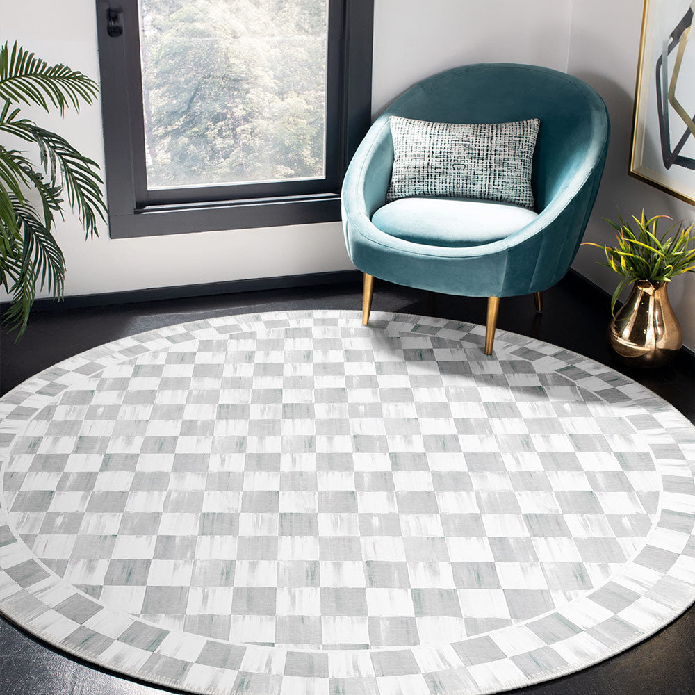 Round checkered rug in a room with a teal chair and decorative elements.