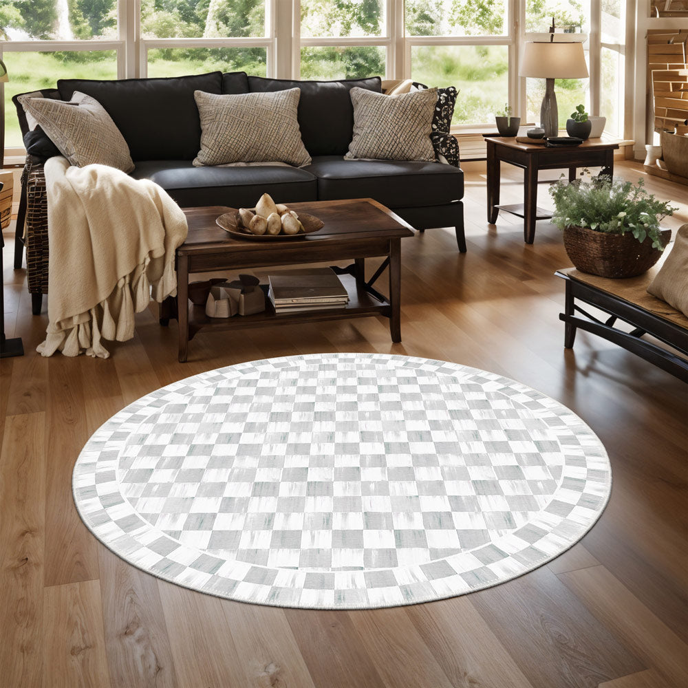 Round checkered rug on a wooden floor in a living room setting.