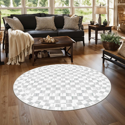 Round checkered rug on a wooden floor in a living room setting.