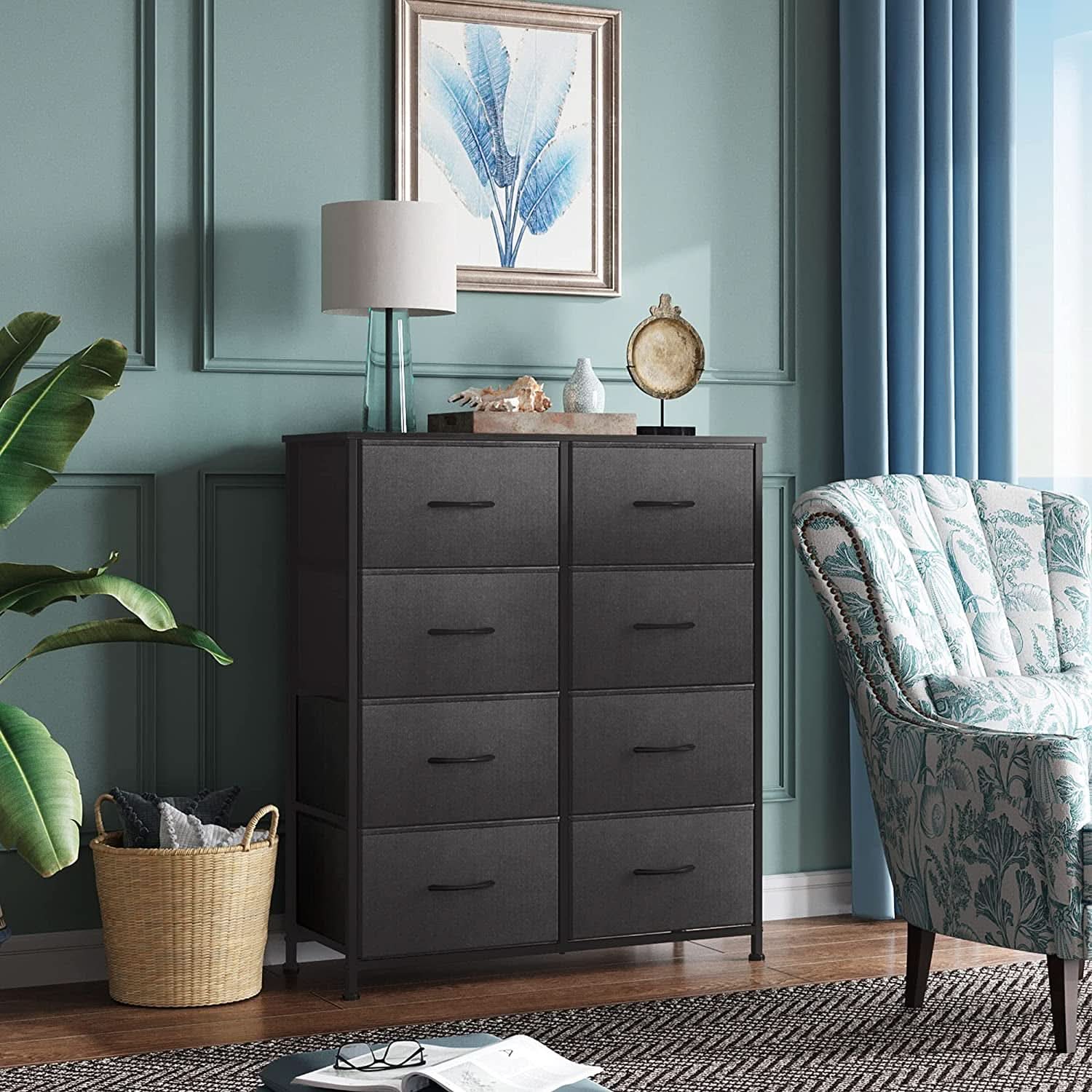 Dark wooden dresser in a room with a green wall, chair, and decorative items.