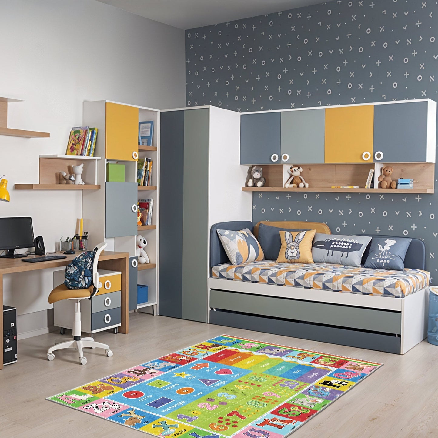 Children's room with a study area, bed, and colorful rug.