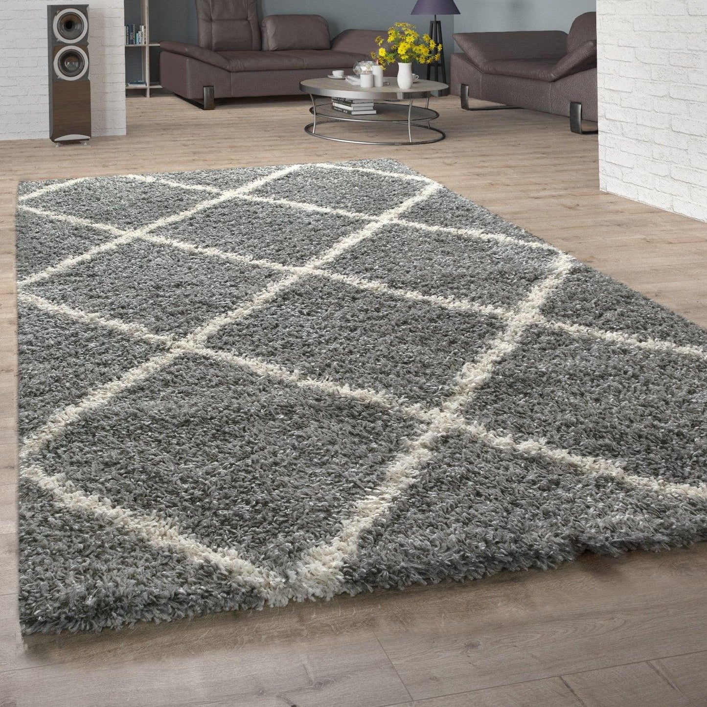 Gray checkered rug on a wooden floor with a living room in the background