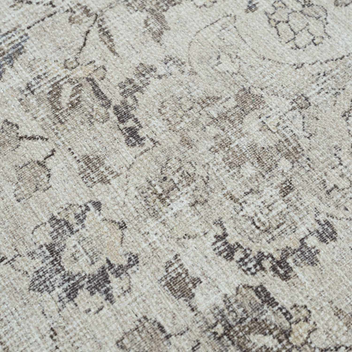 Close-up of a textured patterned rug with neutral colors.