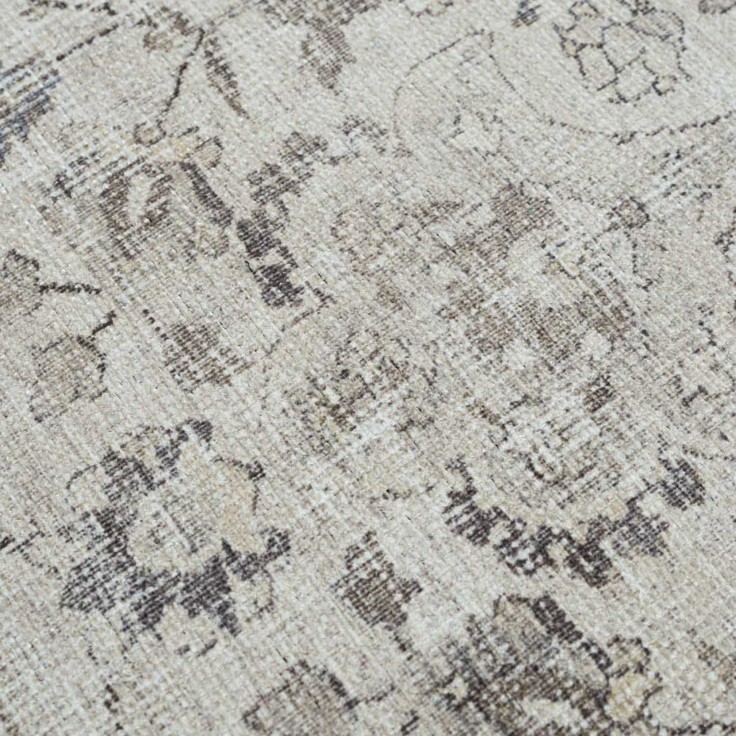 Close-up of a textured patterned rug with neutral colors.