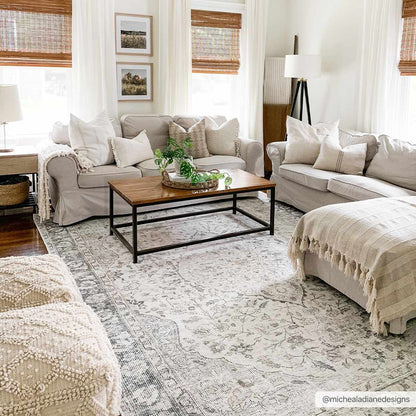Living room with beige sofas, a wooden coffee table, and decorative elements.