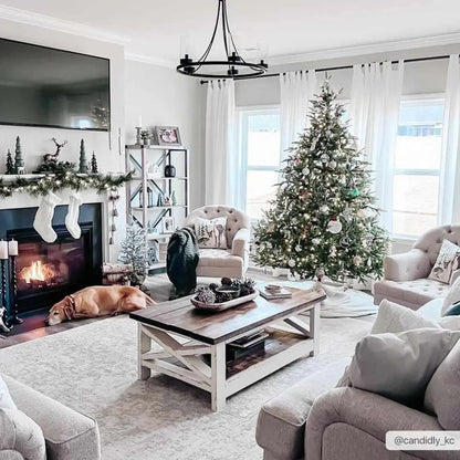 Cozy living room with Christmas decorations, including a tree, stockings, and fireplace.