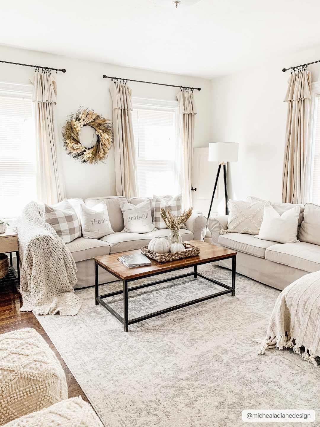 Cozy living room with beige sofas, a wooden coffee table, and decorative elements.