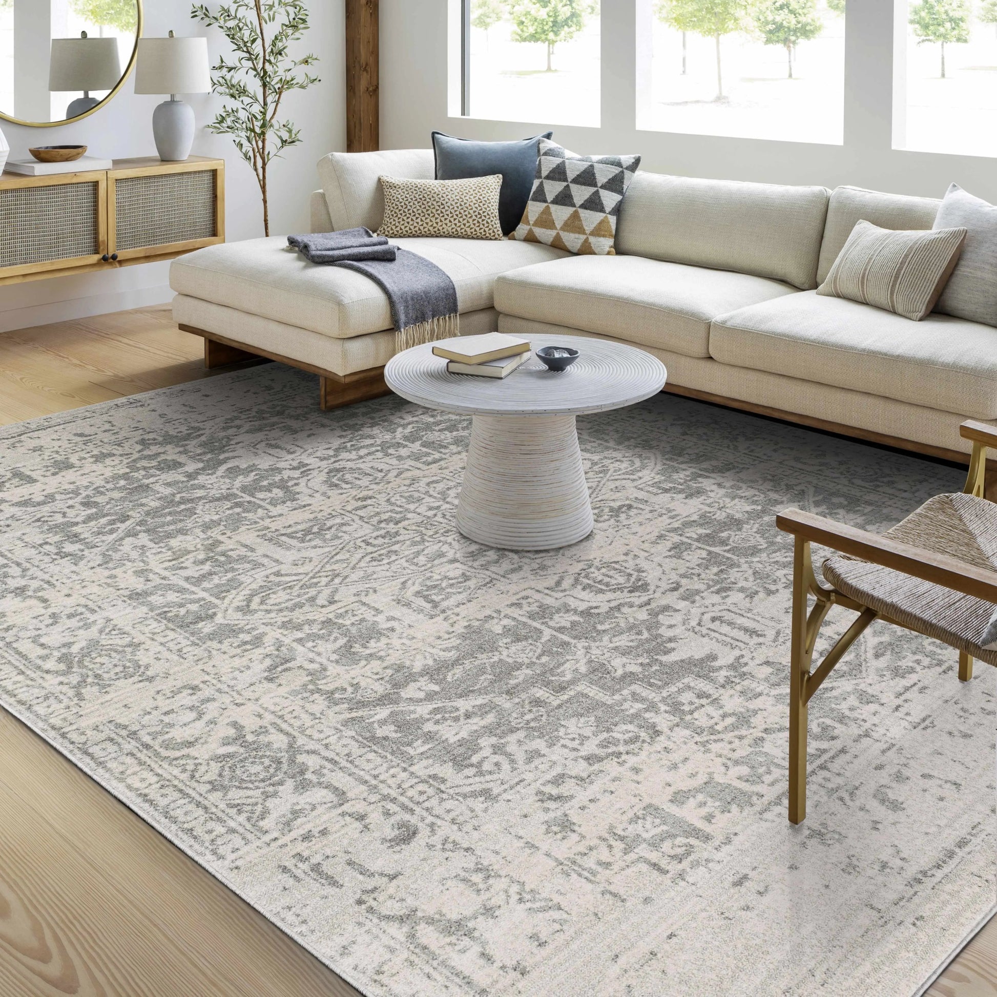 Living room with a beige sectional sofa, coffee table, and patterned rug.