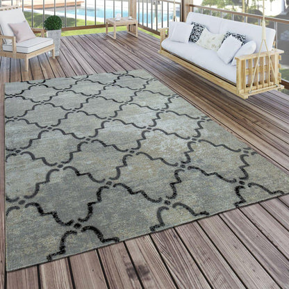 Patterned rug on a wooden deck with outdoor furniture in the background
