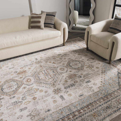 Living room with a patterned rug, beige sofa, and armchair.