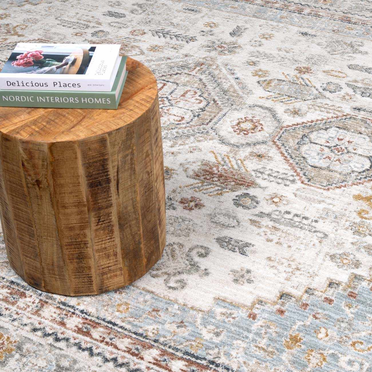 Wooden stool with a book on a patterned rug