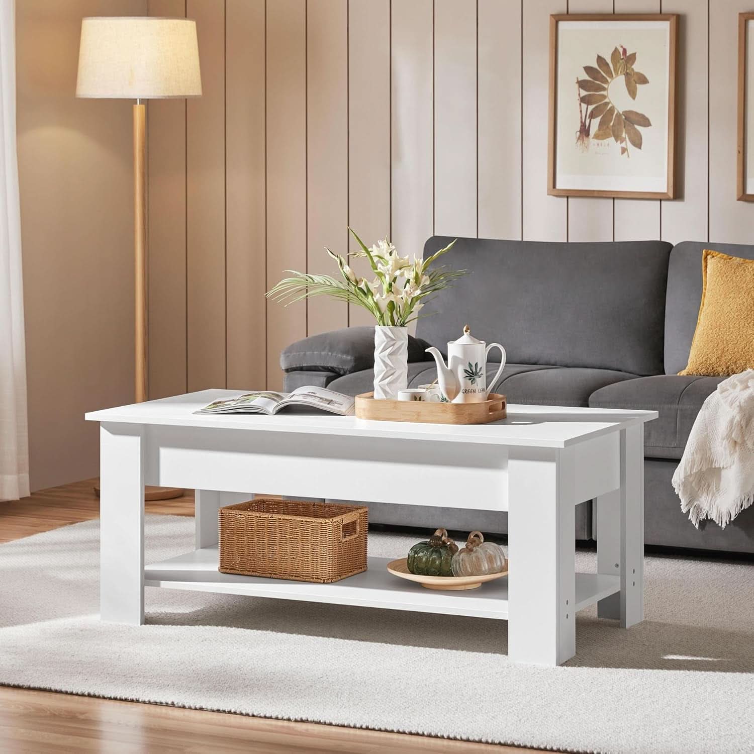 Living room with a white coffee table, gray sofa, and decorative items.