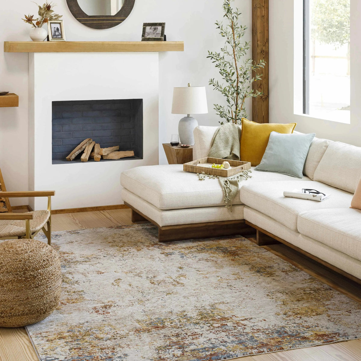 Modern living room with a sectional sofa, rug, and decorative items.