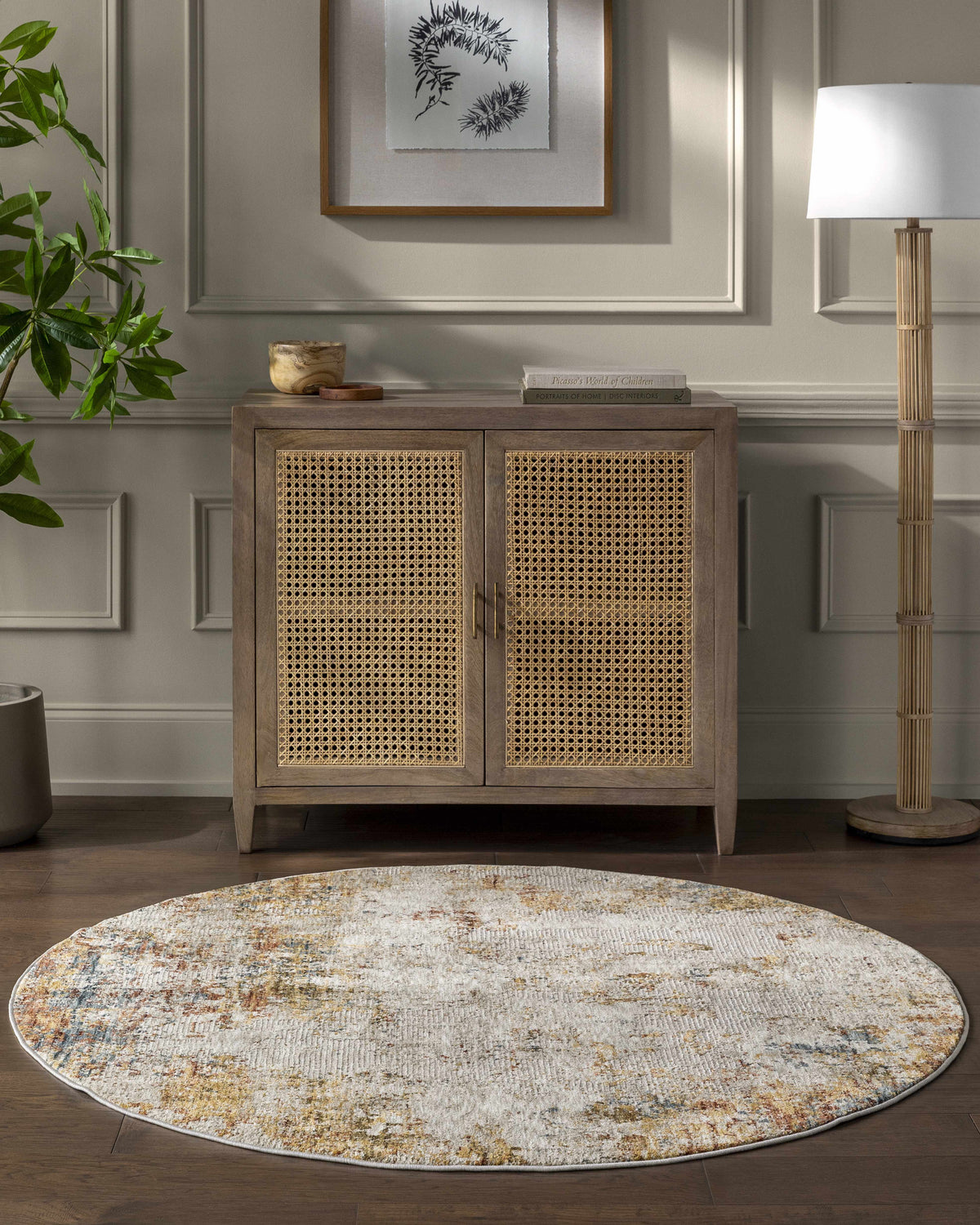 Wooden cabinet with wicker doors in a room with a round rug, plant, and lamp.