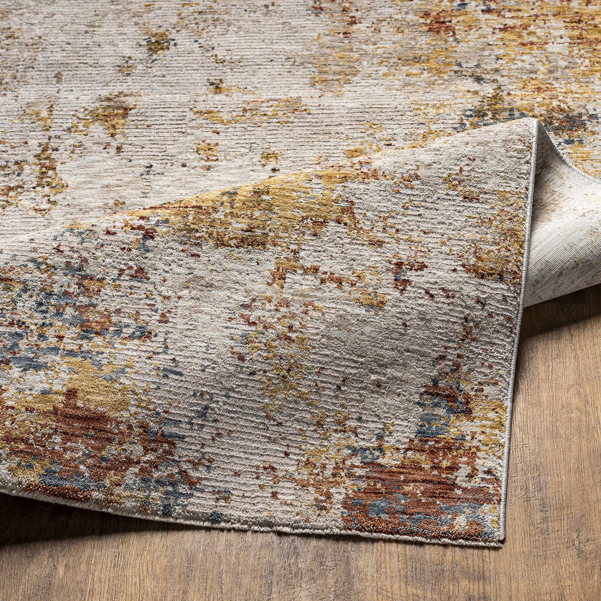 Textured area rug with multicolor pattern on a wooden floor