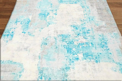 Abstract patterned rug with blue and white colors on a wooden floor.