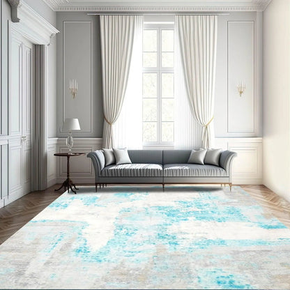 Modern living room with a gray sofa and a decorative rug featuring blue and white abstract patterns.