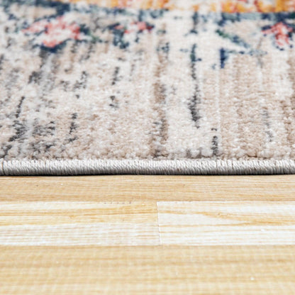 Close-up of a rug with a floral pattern on a wooden floor.