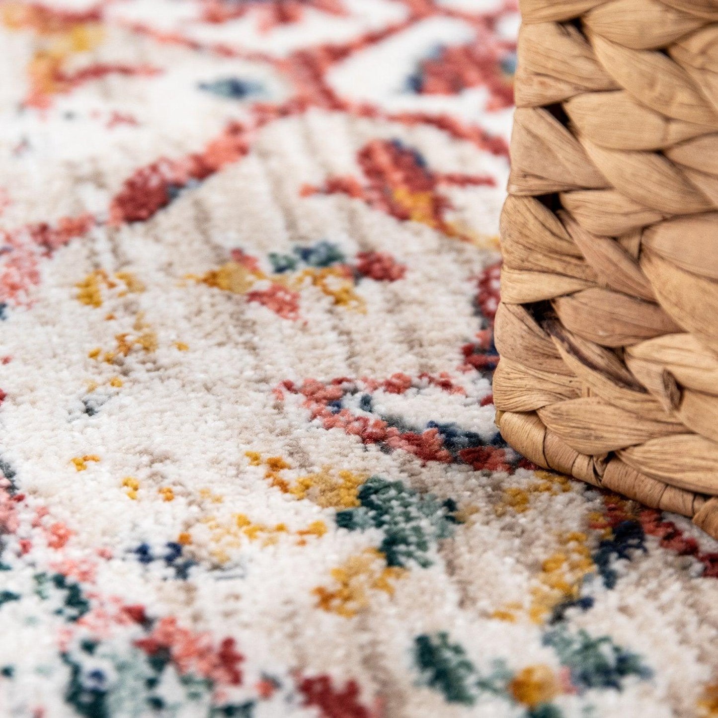 Close-up of a textured rug with a woven basket on top