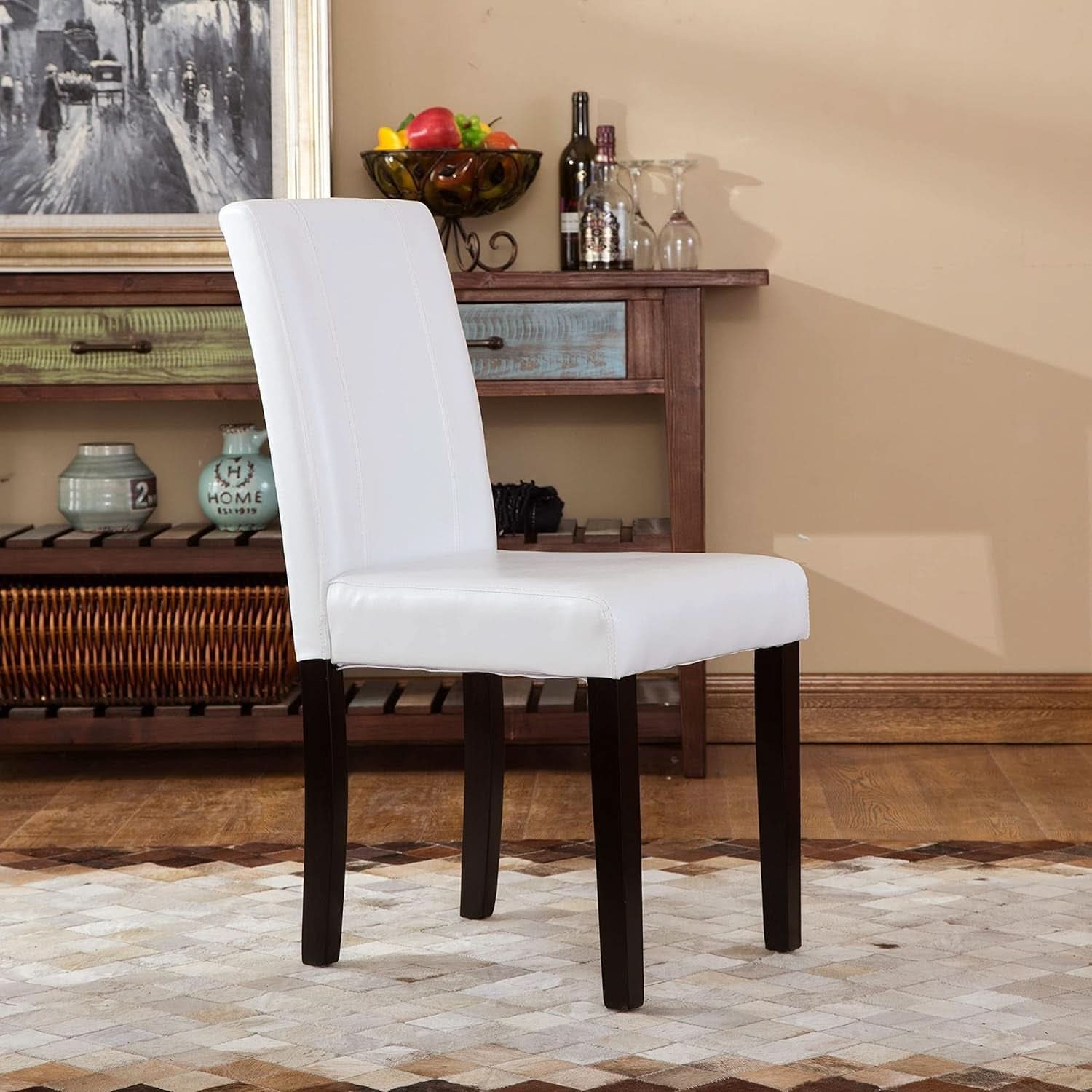 White chair with dark wood legs in a room with a wooden shelf and decor.