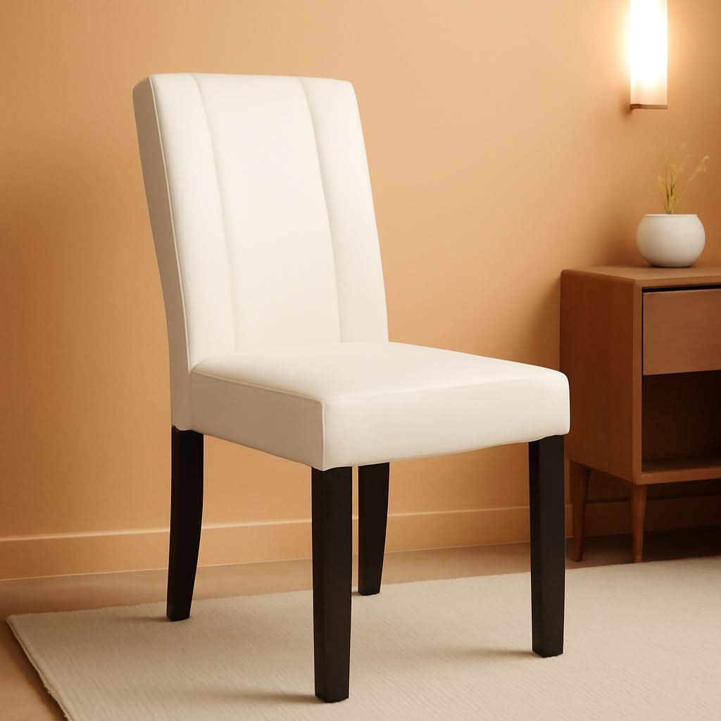 White chair with black legs against a beige wall with a wooden side table.