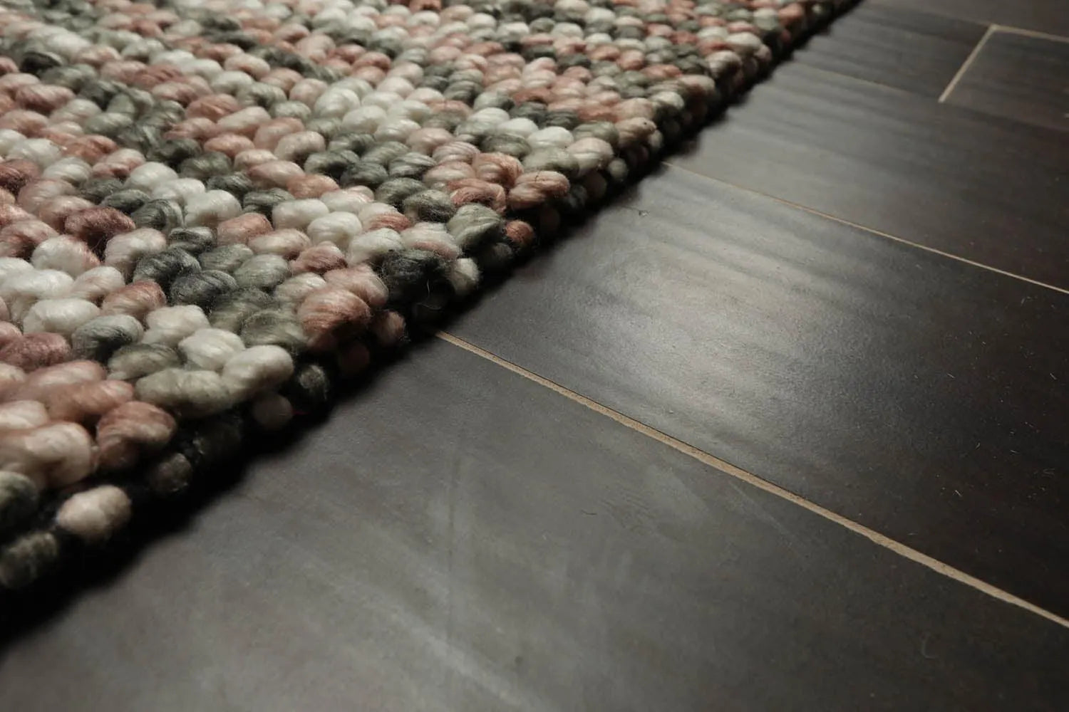 Textured area rug on a dark tiled floor