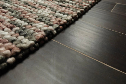 Textured area rug on a dark tiled floor