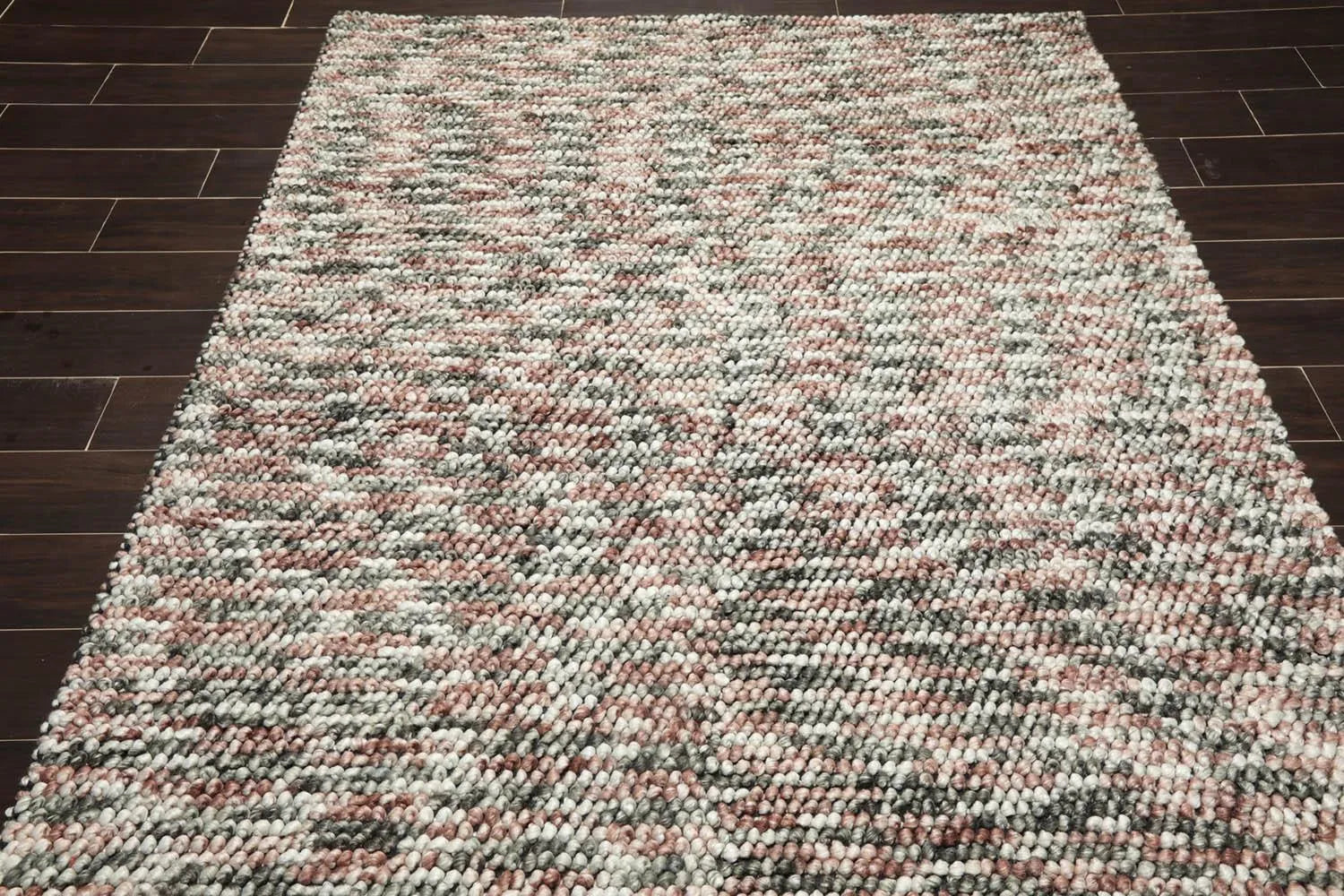 Multicolored textured rug on a wooden floor