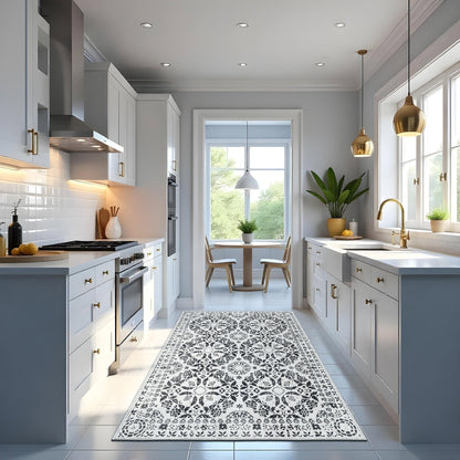 Modern kitchen with gray cabinets, white countertops, and a decorative rug on the floor.