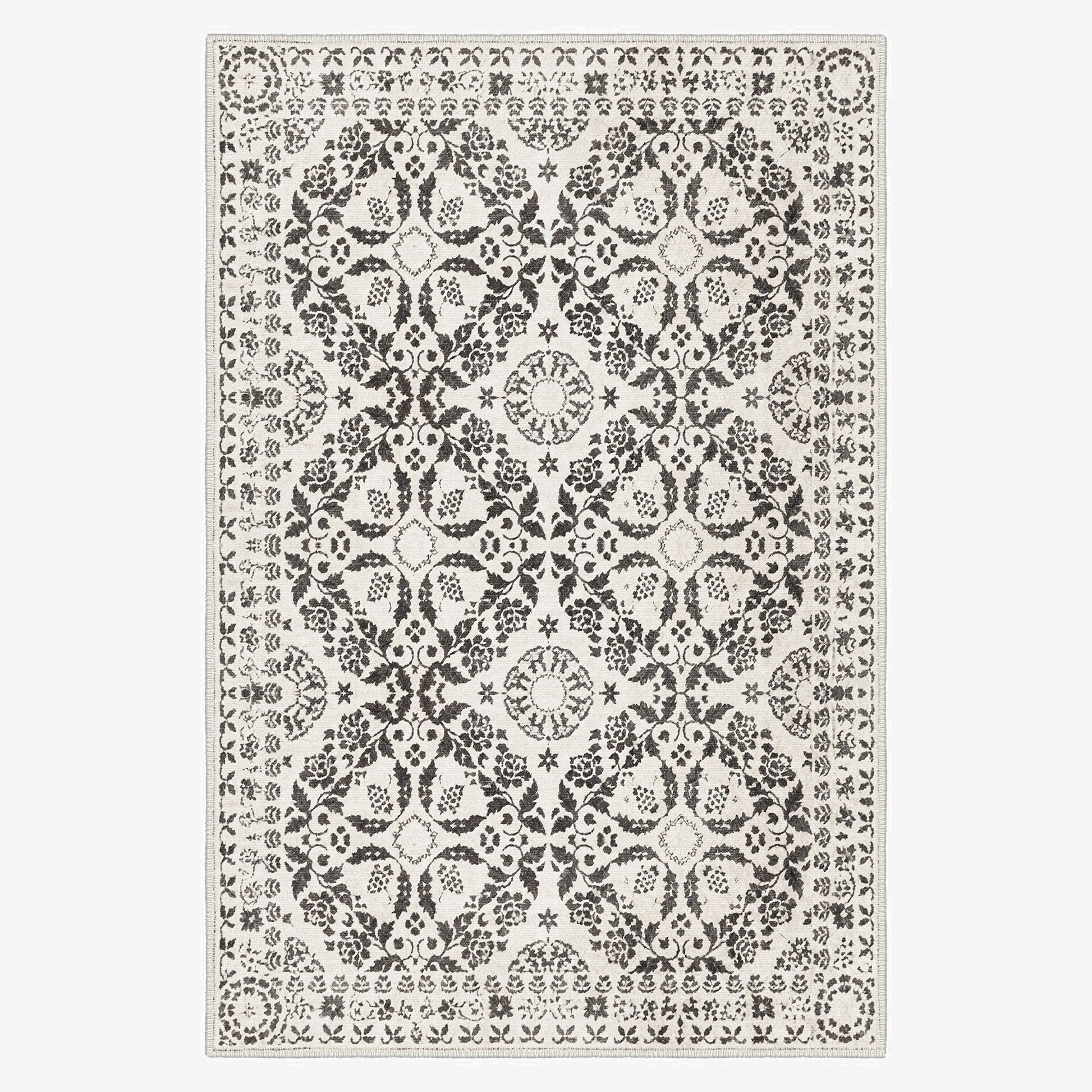 Decorative rug with a black and white pattern on a plain background