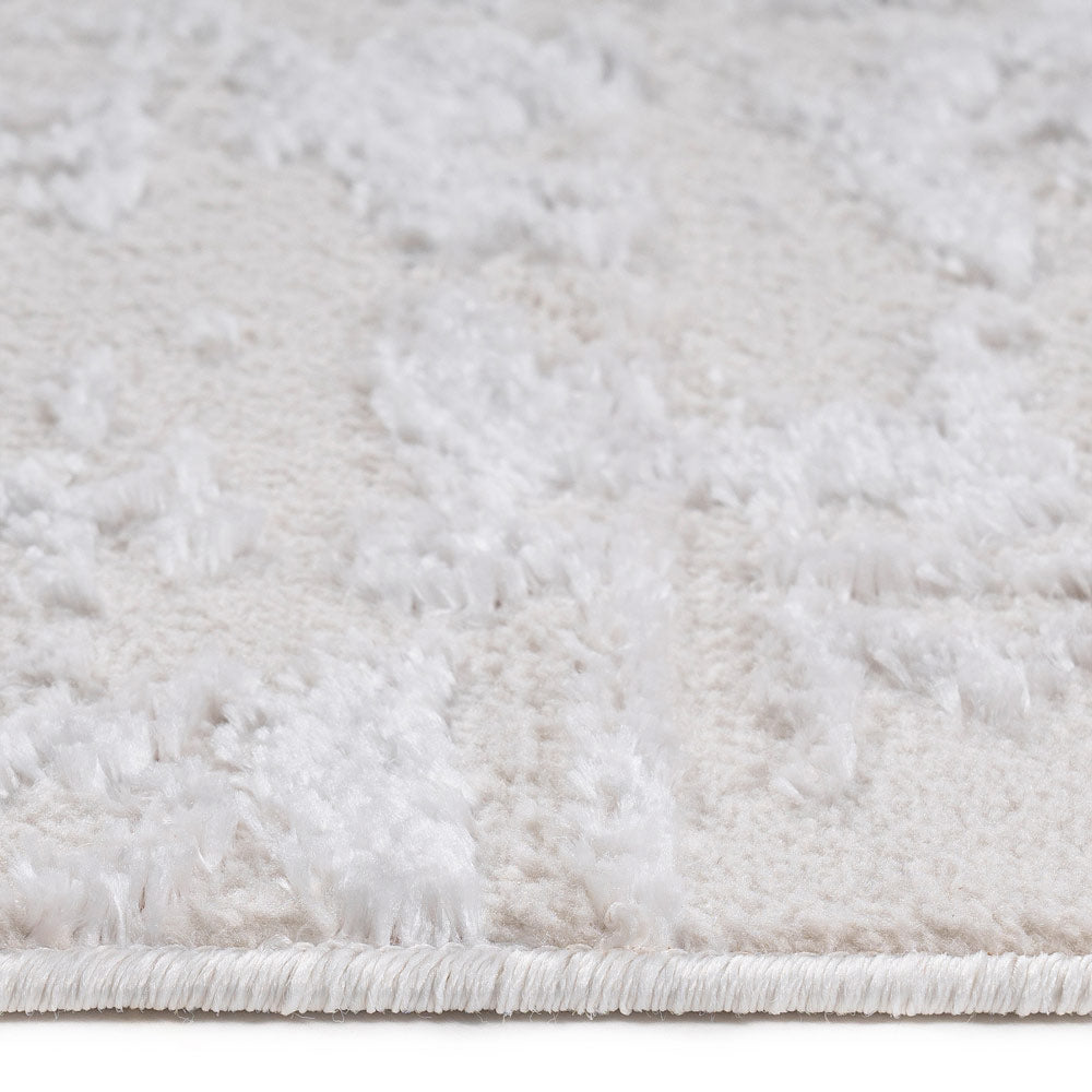 Close-up of a textured white rug with a subtle pattern