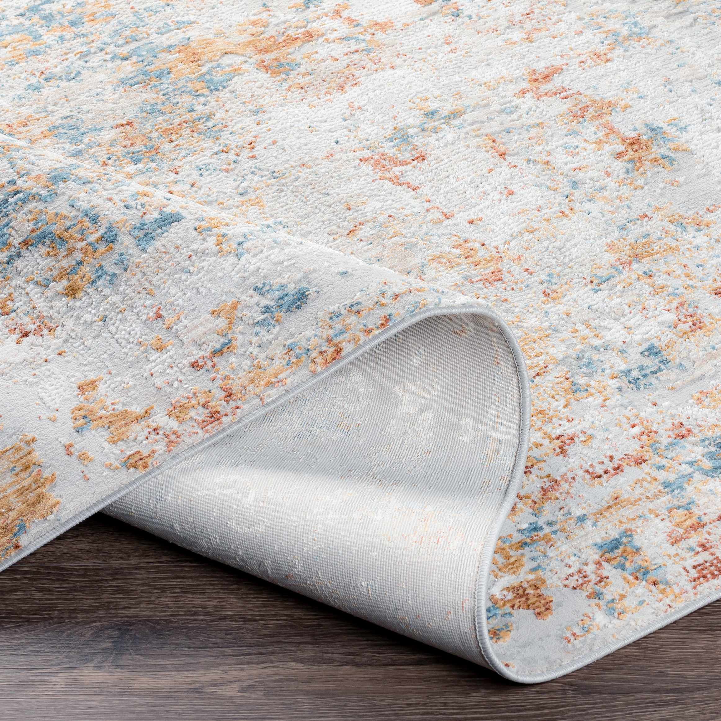 Rolled-up area rug with a textured pattern on a wooden floor