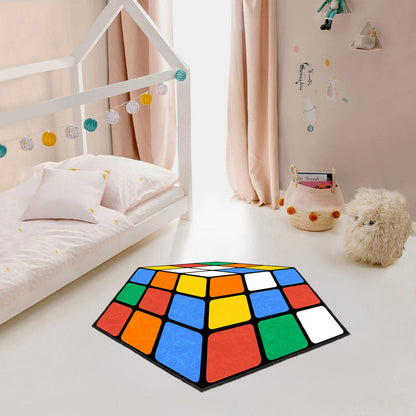 Colorful geometric rug on a light-colored floor in a room with a bed and decorative elements.