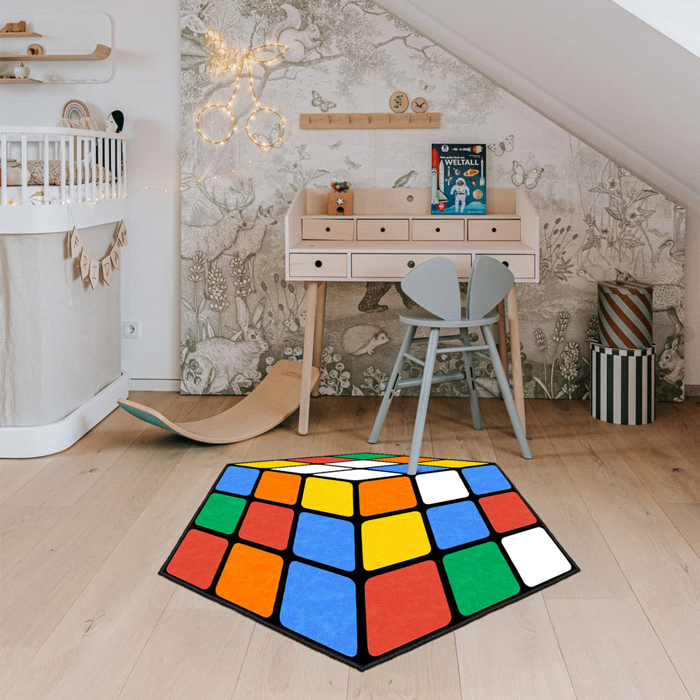 Colorful geometric rug on a wooden floor with a child's desk and chair in the background.